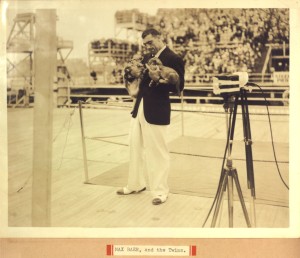 Heavyweight boxer Max Baer posing for the cameras with lion cubs 